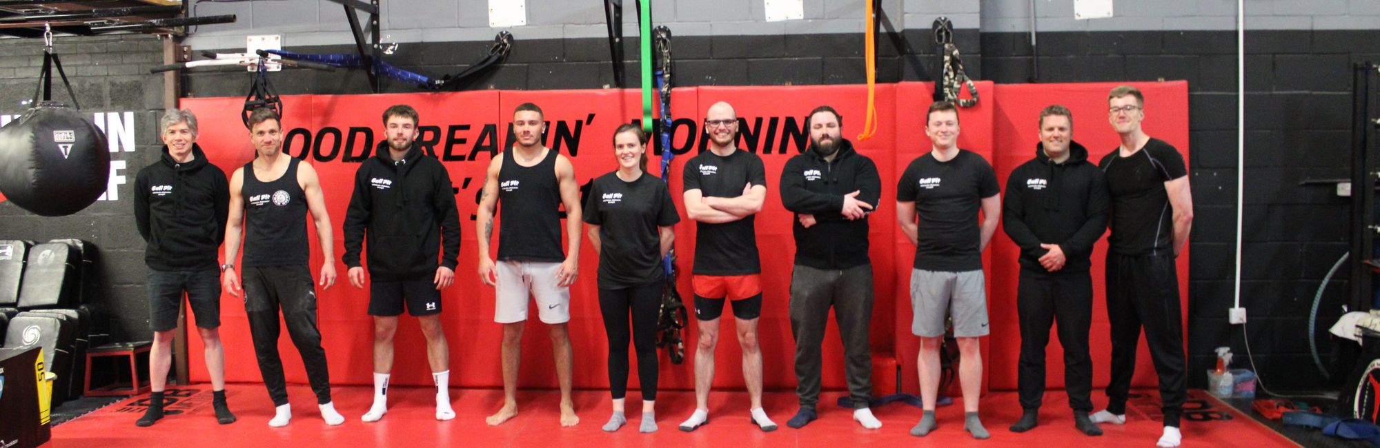 an all-levels class at Cali Fit, with a full number of members posing for a photo