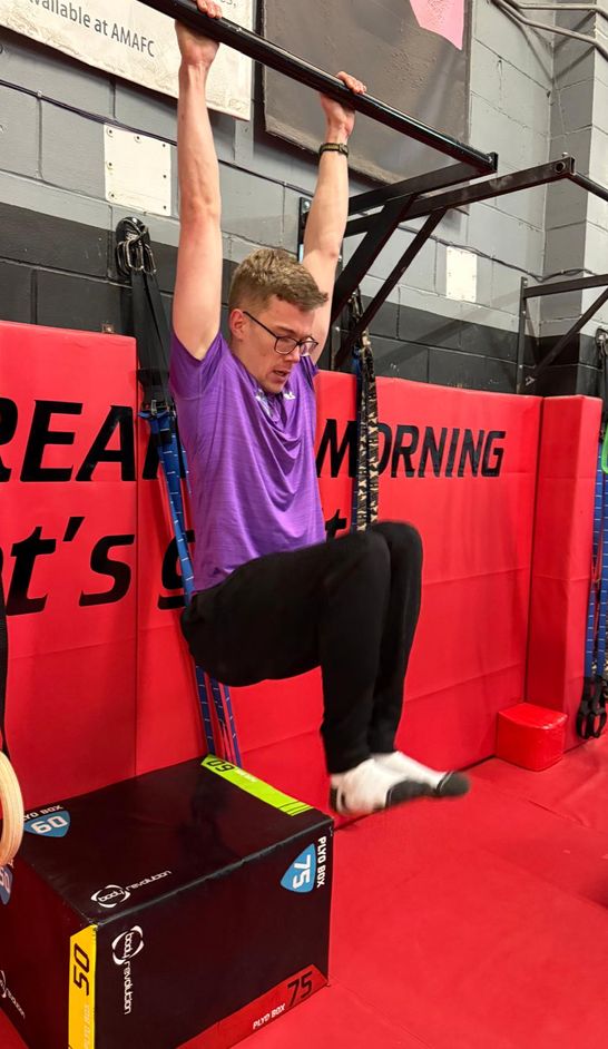 John, a calisthenics coach, performing a pull up