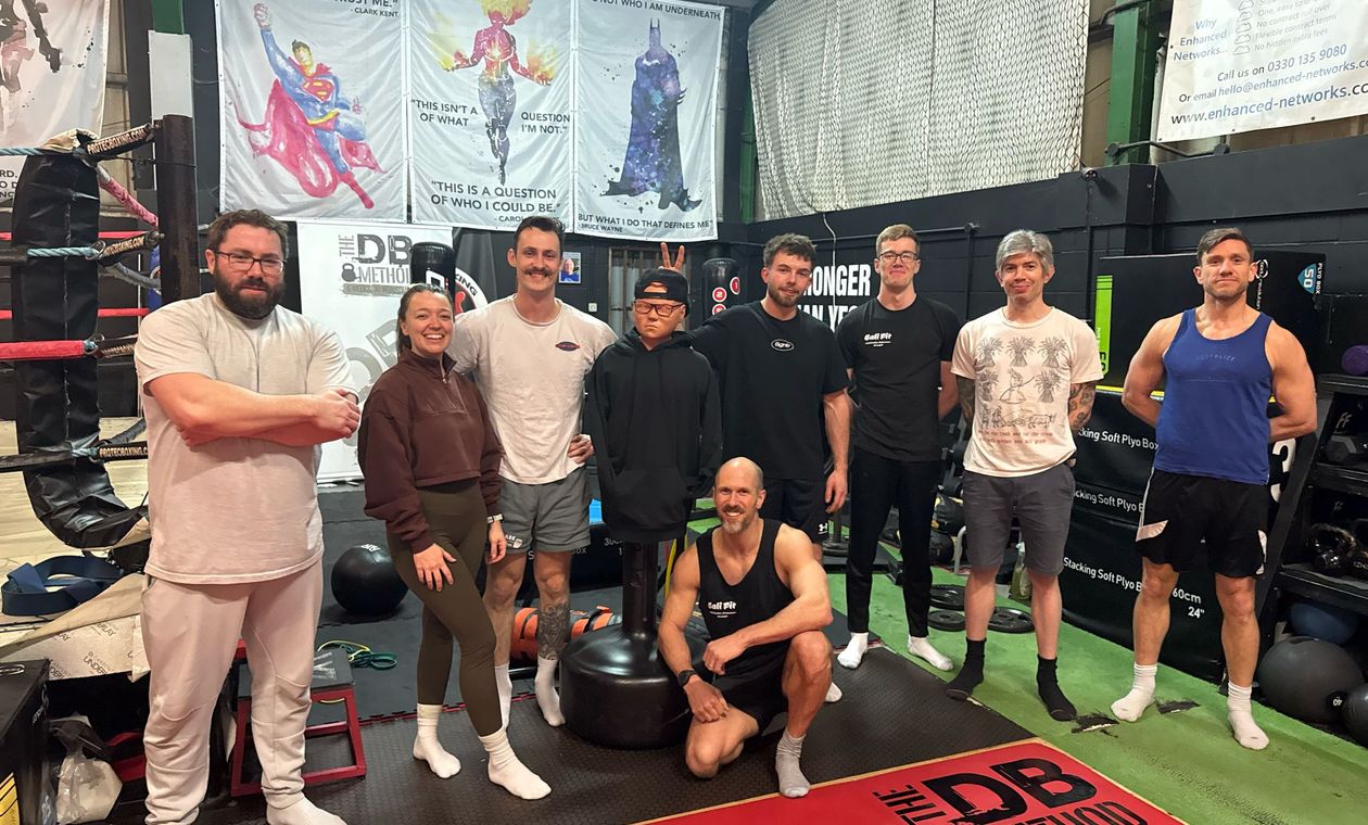 a calisthenics women-only class with a full club posing for a photo
